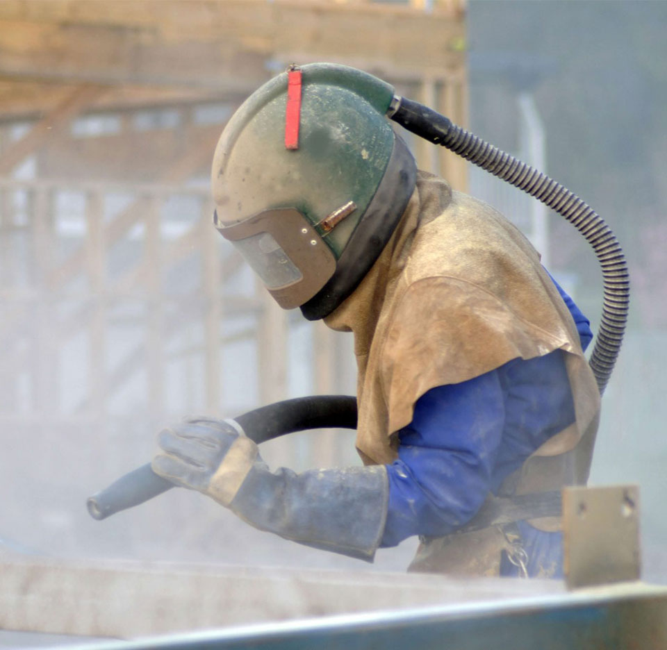 Industrial abrasive blasting for export-ready equipment